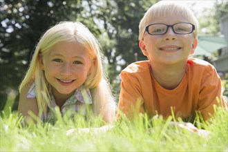 Caucasian children smiling in backyard