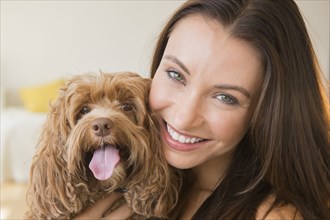 Caucasian woman holding pet dog
