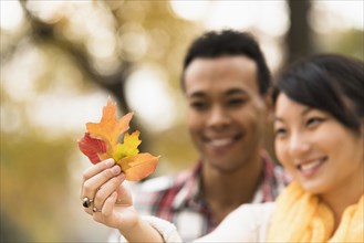 Couple admiring autumn leaves outdoors