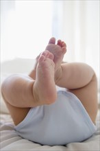 Close up of legs of mixed race baby