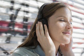 Close up of Caucasian woman listening to headphones