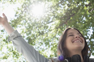Low angle view of Caucasian woman cheering outdoors