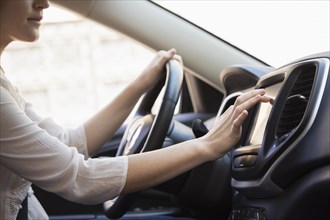 Caucasian woman using GPS system in car