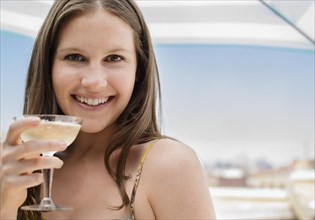 Caucasian woman drinking cocktail outdoors