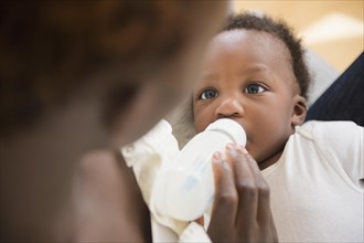 Close up of Black mother feeding baby boy