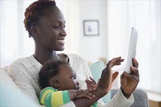 Close up of Black mother and baby boy using digital tablet