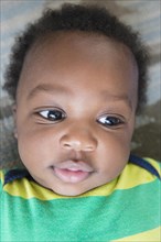 Close up of smiling face of Black baby boy