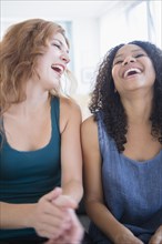Women laughing on sofa
