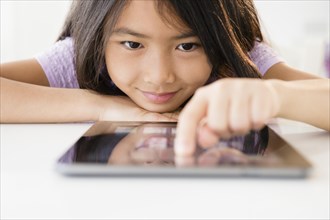 Close up of Vietnamese girl using digital tablet