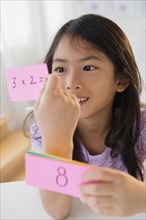Vietnamese girl studying math with flash cards