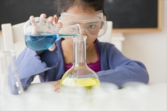 Vietnamese student doing science experiment in classroom