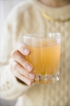 Close up of Caucasian woman holding glass of punch