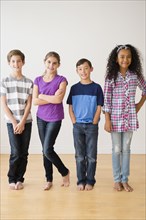Barefoot children smiling in studio