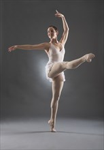 Hispanic ballet dancer posing on tip toe