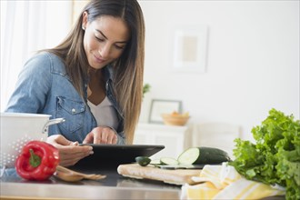Caucasian woman using digital tablet for recipe