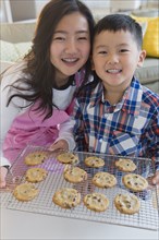 Asian brother and sister baking cookies