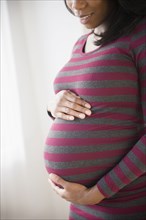 Black pregnant woman admiring her stomach
