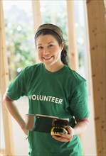 Mixed race volunteer helping build house