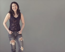 Mixed race woman wearing ripped jeans