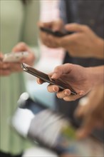 Close up of hands of people texting with cell phones