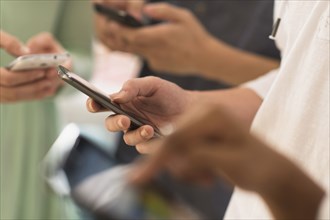 Close up of hands texting on cell phones