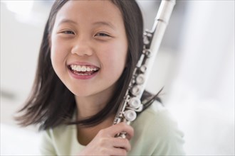 Smiling Chinese girl holding flute