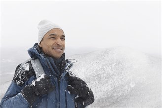 Black man hiking in snow