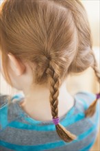 Close up of red hair of Caucasian girl in pigtails