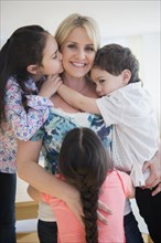 Close up of Caucasian mother and children hugging