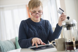 Caucasian woman shopping online on digital tablet