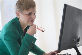 Caucasian businesswoman working at computer