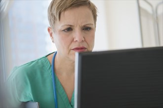 Close up of Caucasian nurse using computer