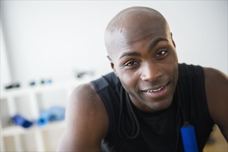 Black man resting in gym