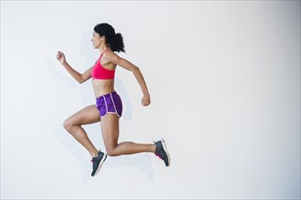 Side view of mixed race woman running