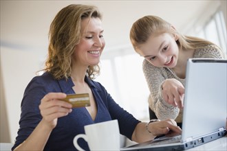 Caucasian mother and daughter shopping online