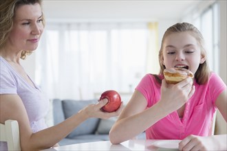Caucasian mother offering daughter healthy food