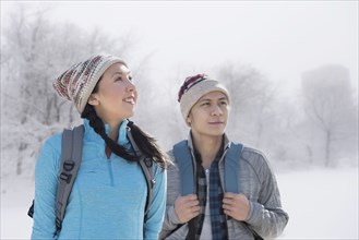 Couple hiking in snowy field