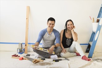 Couple sitting on floor during room remodeling
