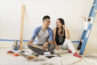 Couple sitting on floor during room remodeling