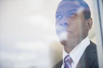 Businessman looking out office window