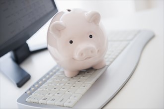 Close up of piggy bank on computer keyboard