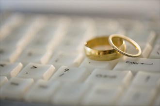 Close up of wedding rings on computer keyboard