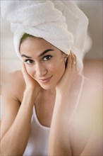 Woman drying her hair with towel