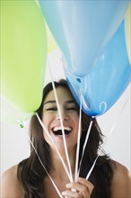 Close up of woman holding bunch of balloons