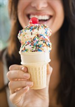 Close up of woman holding ice cream cone