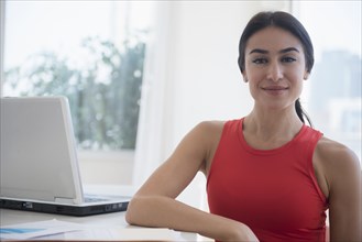 Businesswoman sitting at laptop at desk