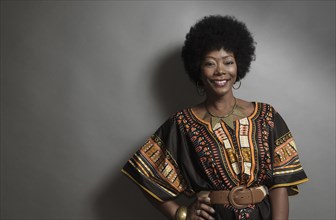 African American woman smiling with hand on hip