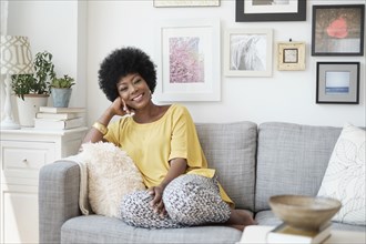 African American woman relaxing on sofa