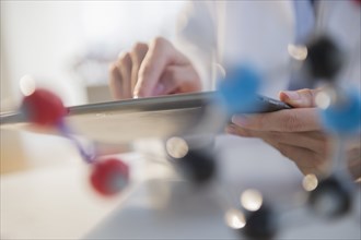 Mixed race scientist using digital tablet in laboratory
