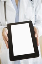 Mixed race doctor showing digital tablet